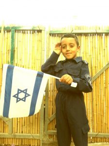 Khaled as a child with Israeli flag (credit: Facebook)
